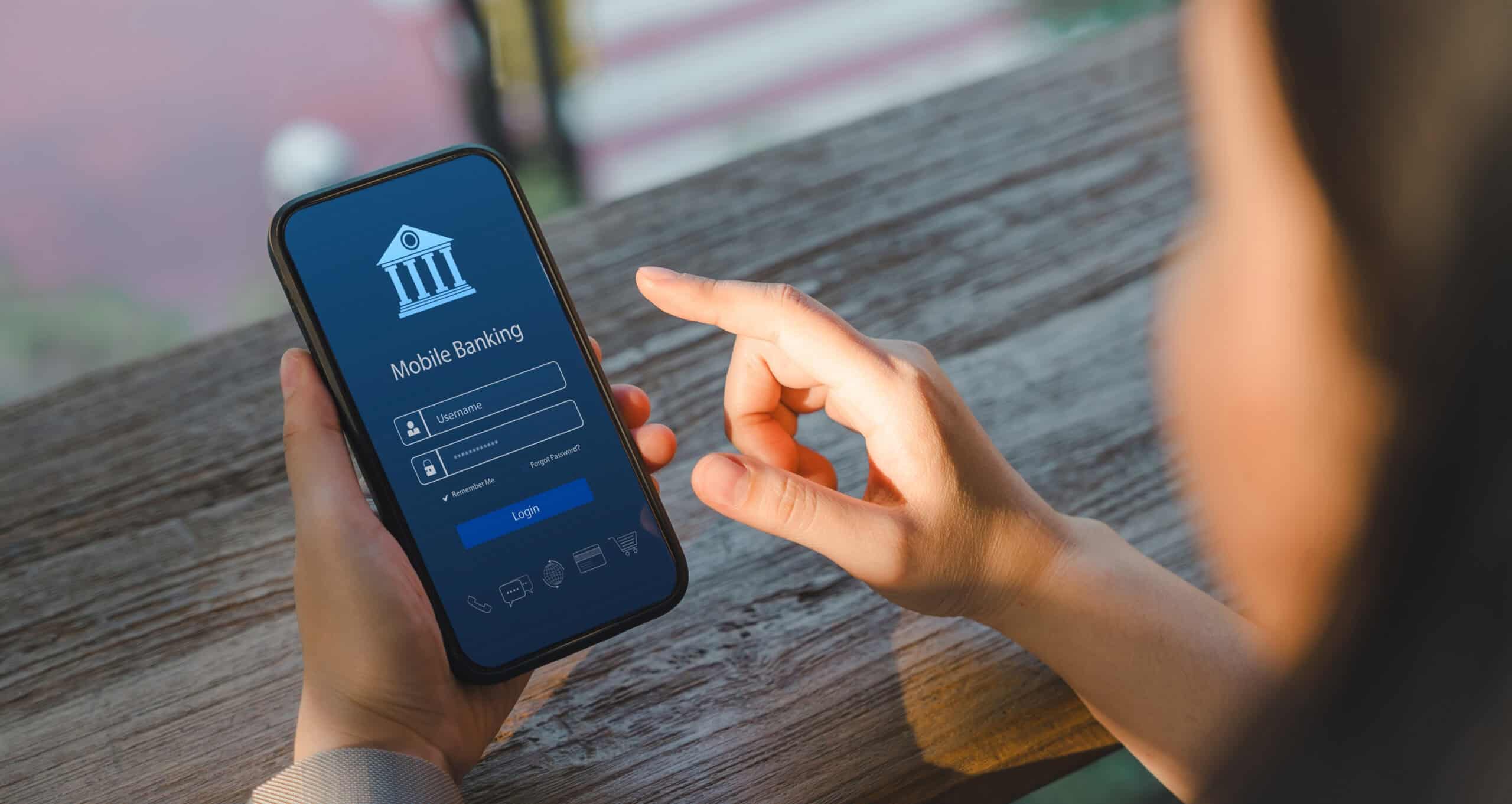 A bank patron signs in to mobile banking on their phone